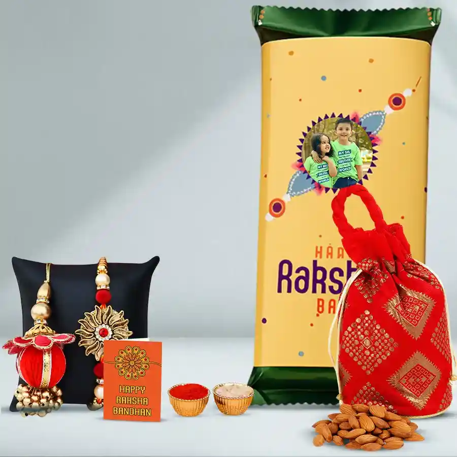 Adore Duo Rakhi and Personalized Chocolates gift set including a custom Cadbury Temptation Bar, almond potli, Bhaiya Bhabhi Rakhi set, and traditional Rakhi accessories displayed beautifully.