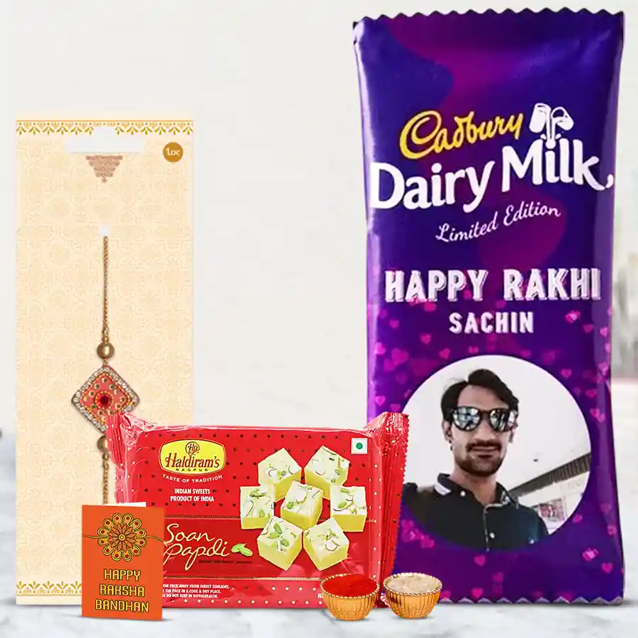 Personalized Chocolate and Rakhi Twin Treat including Cadbury Silk, Haldiram Soan Papdi, a premium Rakhi, Roli, Tilak, and Chawal for Raksha Bandhan celebration.