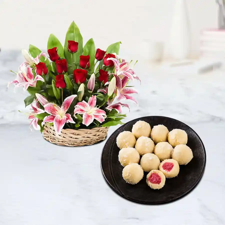 A vibrant basket of 12 roses and 4 pink lilies paired with Khir Kadam sweets, ideal for special celebrations.