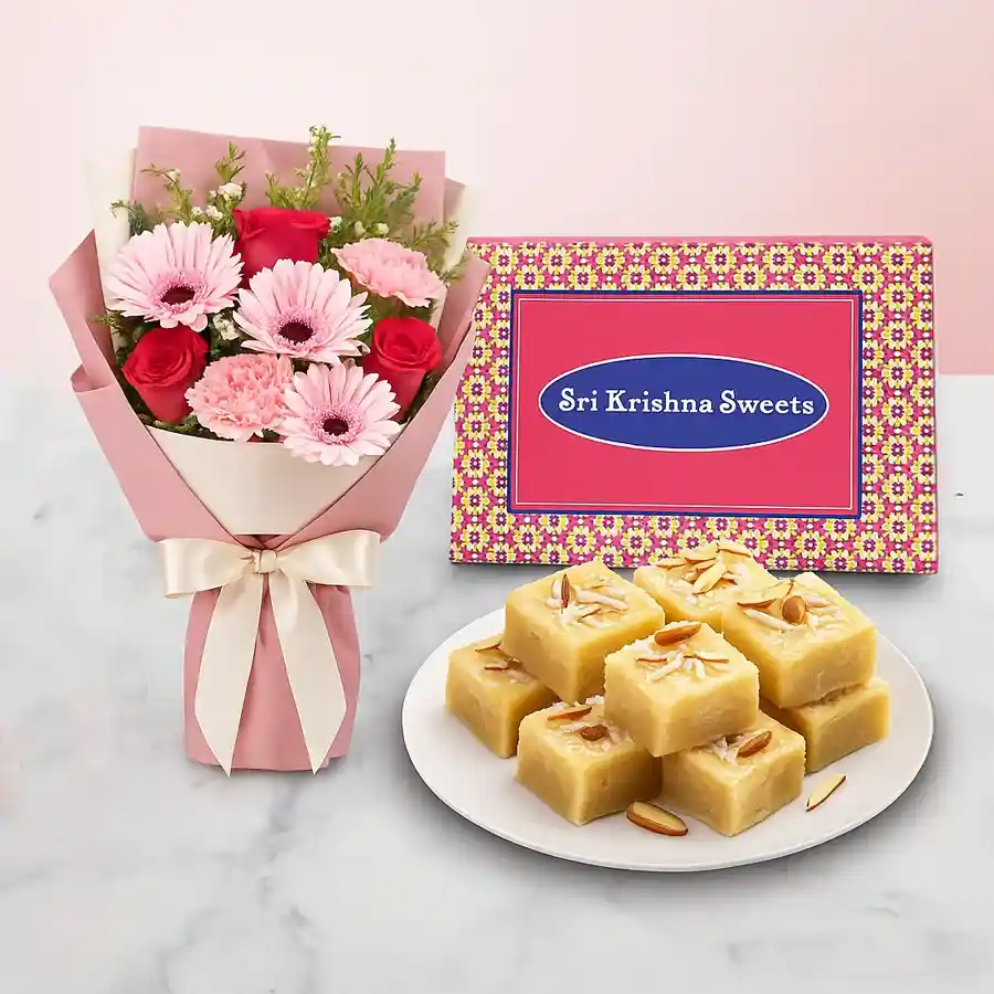 Vibrant mixed flower arrangement and Coconut Barfi combo gift.