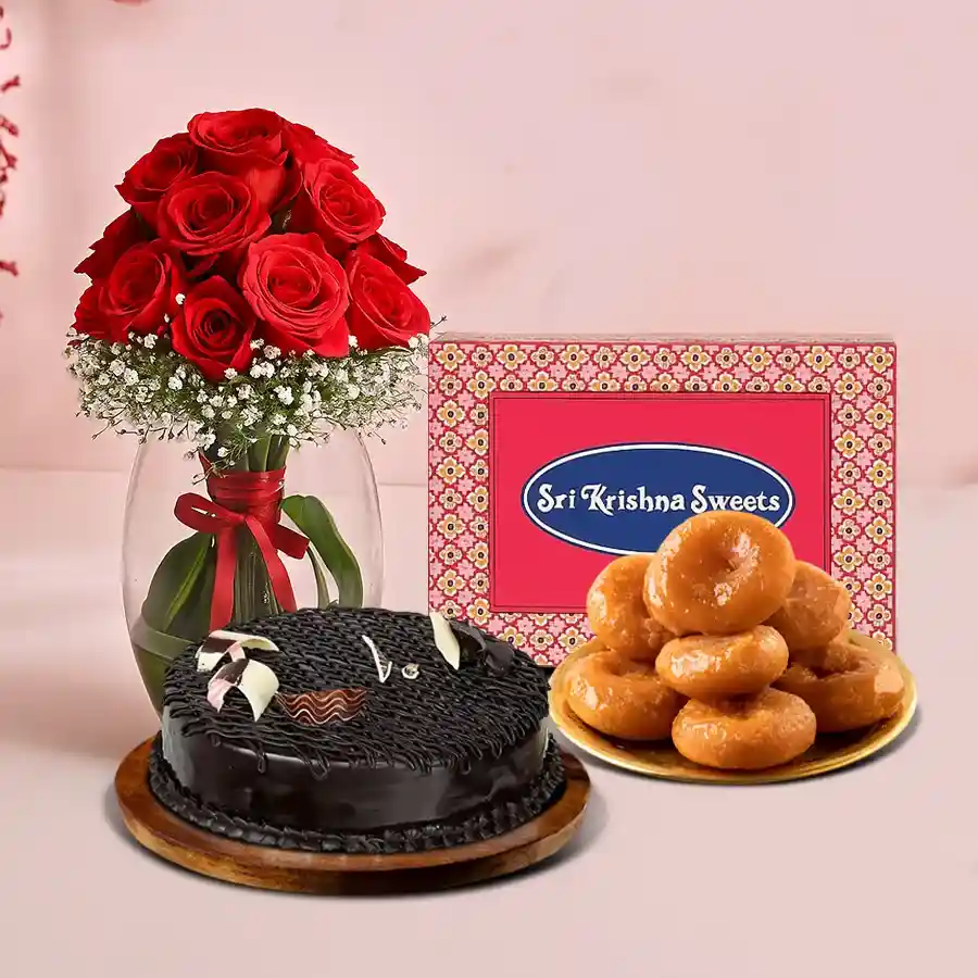 A gift combo featuring 12 red roses in a glass vase, Badusha, and a chocolate cake, perfect for romantic occasions and celebrations.