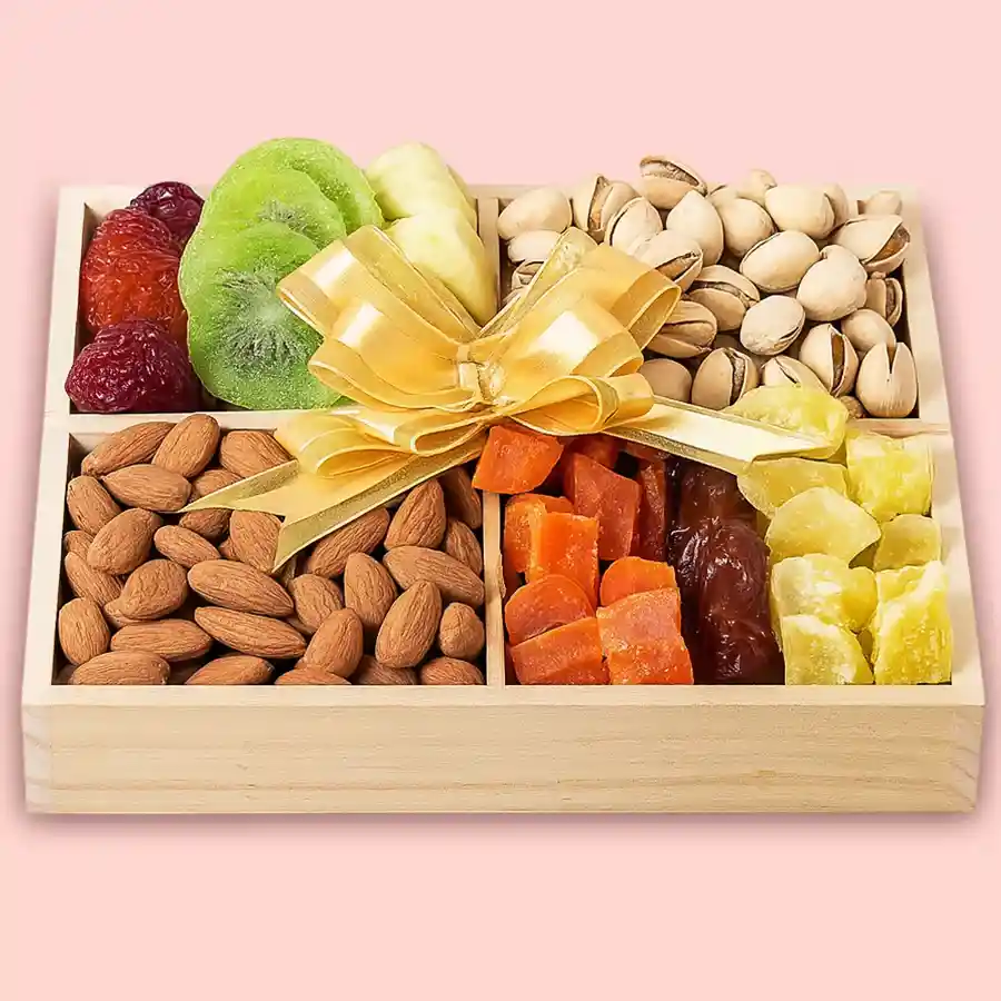 Nutritious Dry Fruits Delight Box featuring almonds, pistachios, dates, dried kiwi, dried apricots, dried amla candy, and a wooden tray.