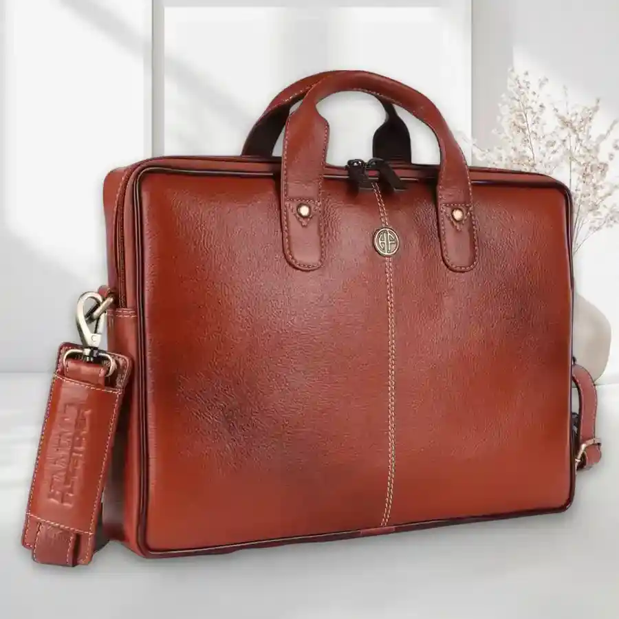 Stylish tan leather laptop bag designed for 14-16 inch laptops, featuring multiple compartments for organization and elegant design.