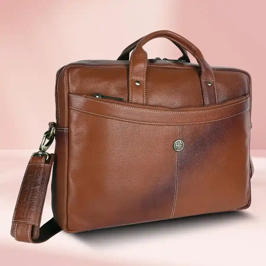 Chic tan leather laptop messenger bag for men, designed for style and practicality, fits up to 16" laptop with multiple compartments.