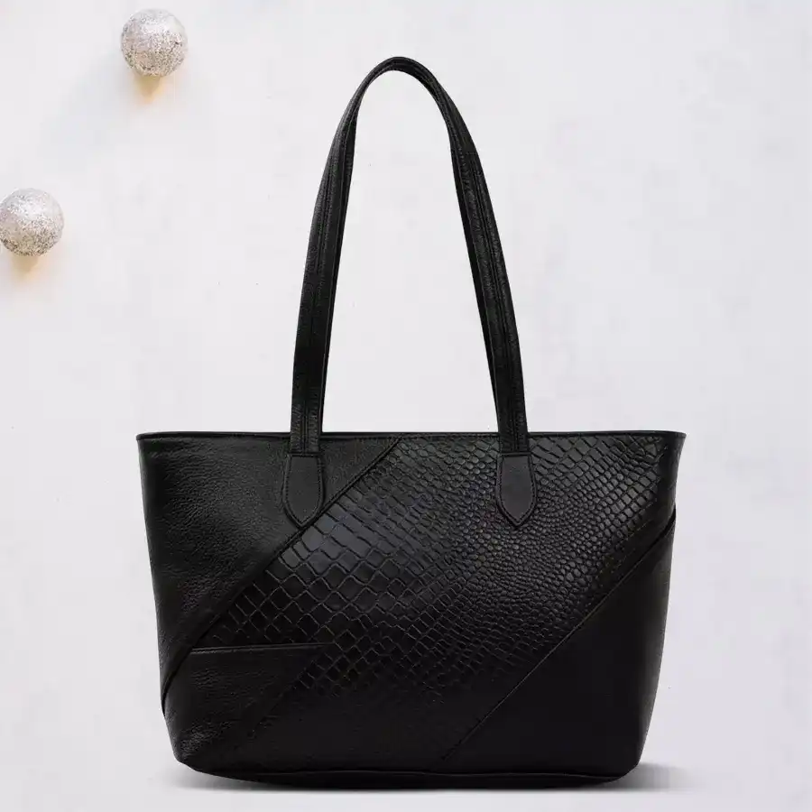 Stylish black shoulder bag with embossed front design, perfect for ladies.