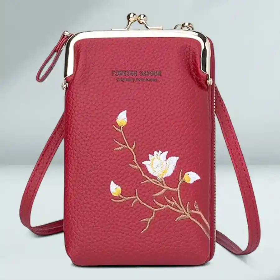 Stylish red crossbody sling bag made of faux leather, featuring compartments for phone, cash, and cards with an adjustable strap.